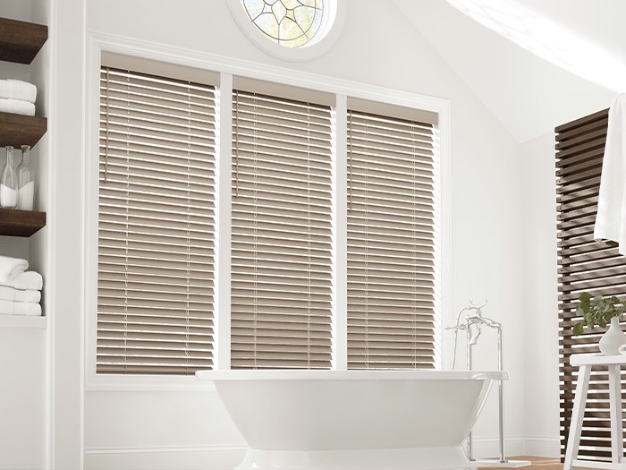 EverWood Alternative Wood Blinds cover windows over a bath tub.